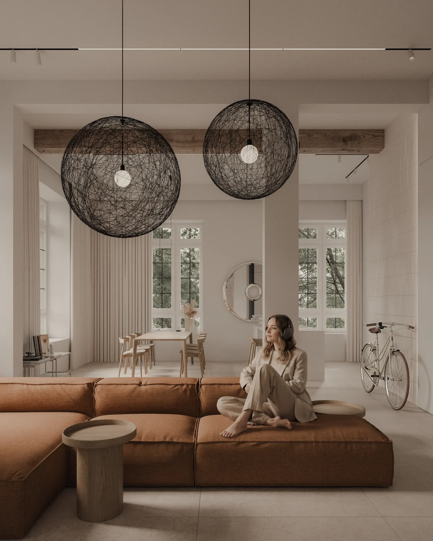Projekt salonu w stylu soft loft z modułową sofą, wysokimi oknami, ażurowymi lampami wiszącymi i otwartą przestrzenią dzienną połączoną z jadalnią.